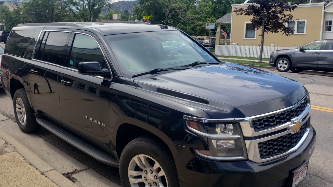 black SUV waiting for a customer at Boulder CO