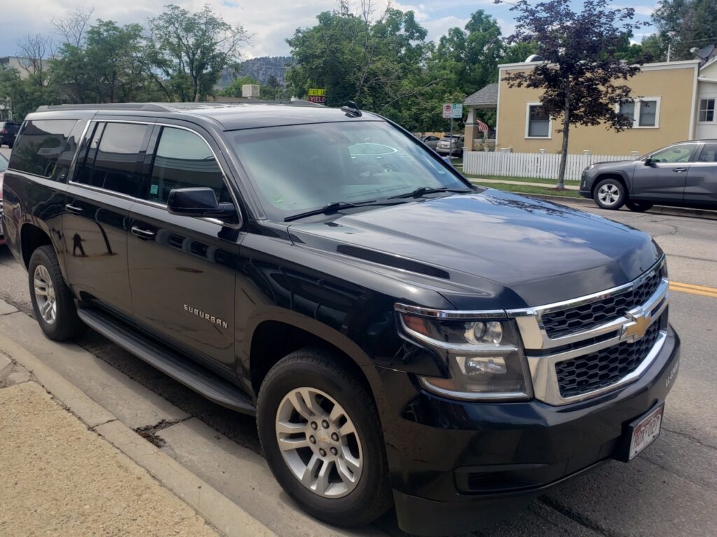 black SUV waiting for a customer at Boulder CO