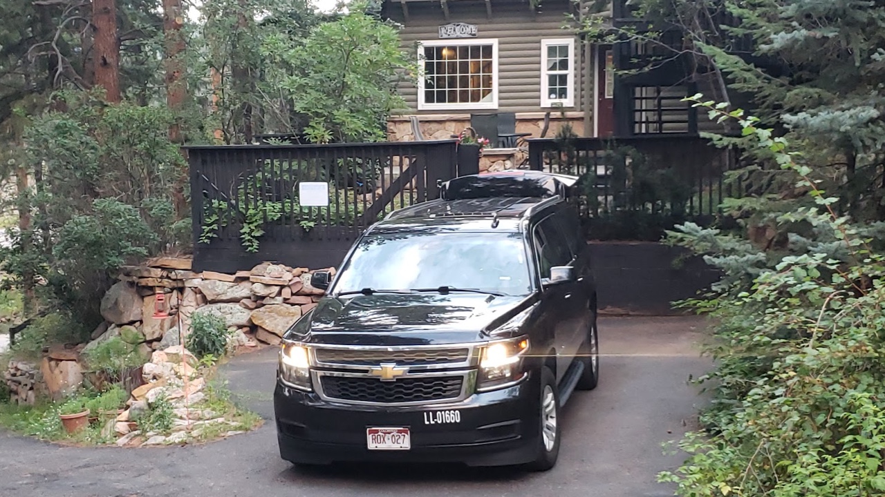 black SUV waiting for a ride outside a private residence at Evergreen Colorado